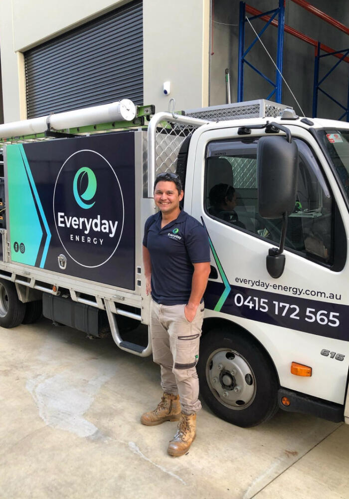 Joshua Garbutt from Everyday Energy standing in front of a white work truck